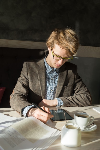 A financial advisor sitting across from a young graduate, reviewing documents and discussing income-driven repayment options. The setting is professional and supportive, highlighting a path toward financial stability with student loan management.