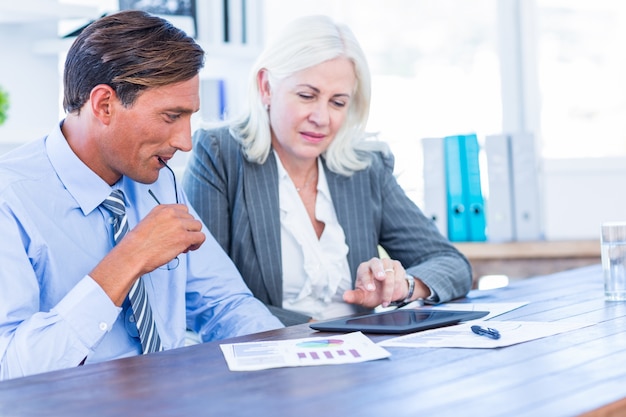 A financial advisor discussing investment options with a client in a bright, modern office, emphasizing trust and professionalism.