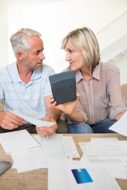 A senior couple reviewing retirement plans with a financial advisor, highlighting the importance of long-term financial security and retirement planning.