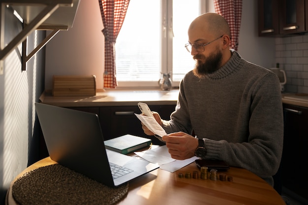 A person using a laptop to research stock prices and tax implications, emphasizing the importance of informed decision-making when participating in an ESPP.