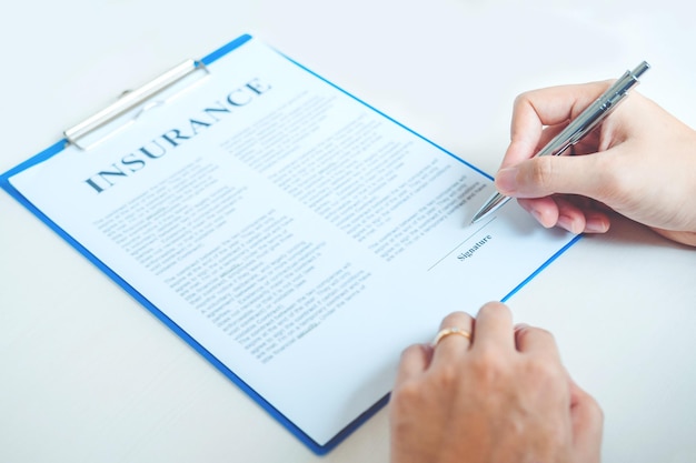 A close-up shot of an insurance policy document highlighting the terms 