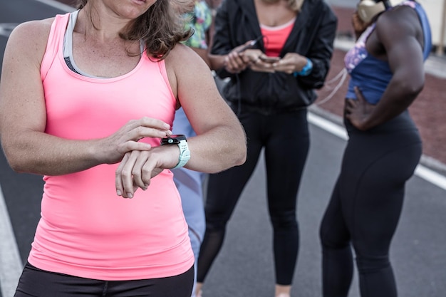 A diverse team of employees participating in a walking challenge, using wearable fitness trackers and sharing their progress on a mobile app.