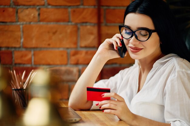 A person using a debit card to pay for glasses at an optometrist's office. The scene is brightly lit and professional, showcasing a typical FSA-eligible purchase.