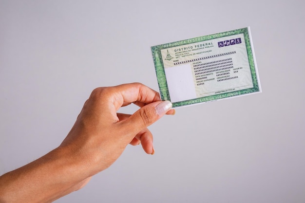 A close-up shot of a hand holding a bond certificate with the details of the bond clearly visible. The certificate should have a watermark or some design that evokes trust and security.