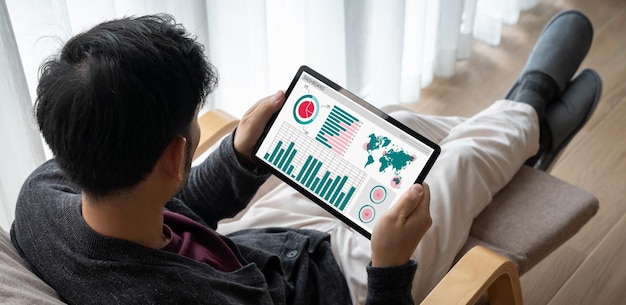 A person using a laptop to research and compare different ETFs, with charts and data displayed on the screen.