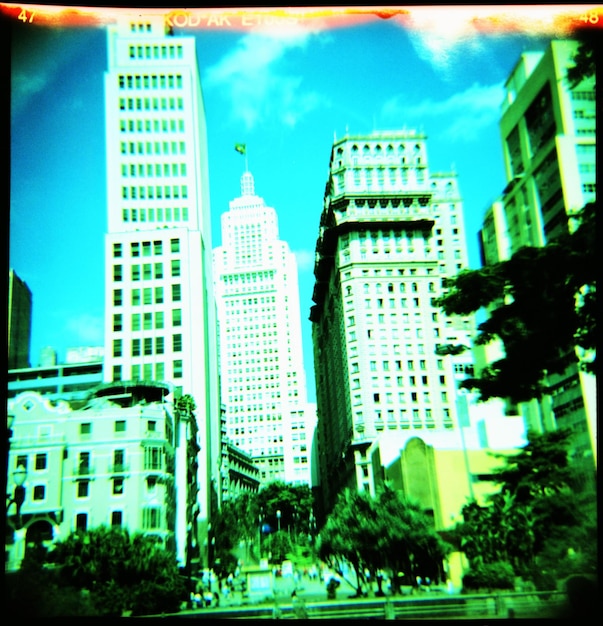A split image showing contrasting economic scenarios: one side depicts a bustling city with thriving businesses, representing economic growth, while the other side shows closed storefronts and unemployment lines, indicating economic recession.
