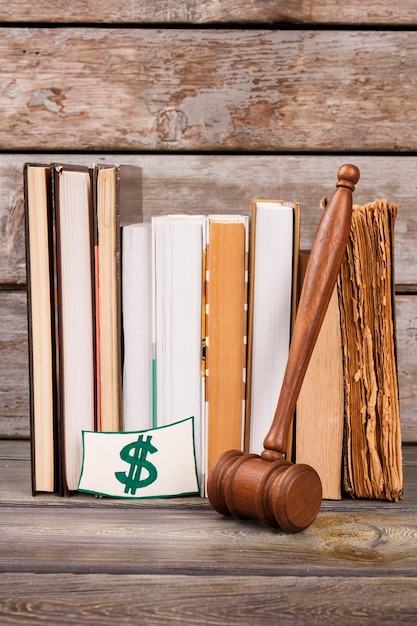 Image depicting a gavel hitting a sound block with student loan documents in the background, symbolizing legislative changes affecting student debt.