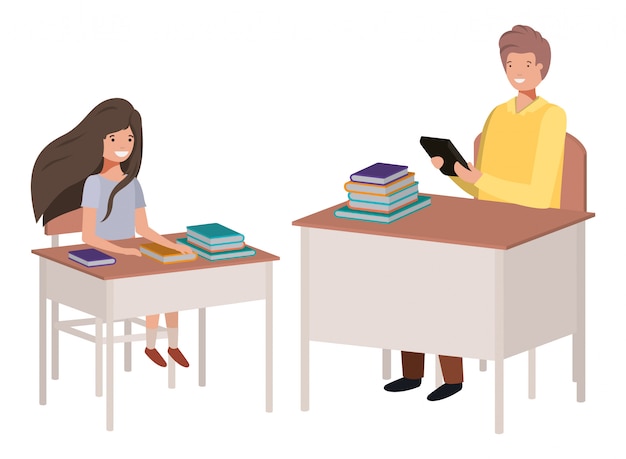 A student sitting at a desk talking to a professor.